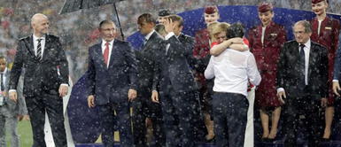 Kolinda Grabar-Kitarovic prefirió mojarse para poder saludar a los miembros de su selección. (Foto: AP) Presidenta de Croacia se quedó sin paraguas mientras Putin tenía dos