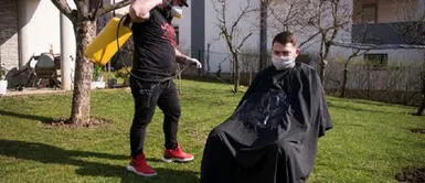 Peluquero corta el cabello al aire libre de forma gratuita a jubilados y pobres Peluquero corta el cabello al aire libre de forma gratuita a jubilados y pobres
