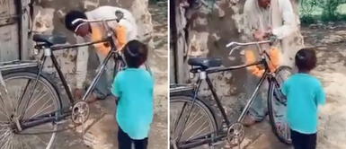 Niño valora y salta de alegría el regalo hecho por su padre: una bicicleta de segunda mano Niño salta de alegría y valora el regalo hecho por su padre: una bicicleta de segunda mano